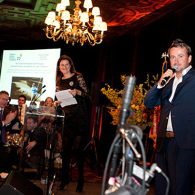 Graeme thanks a generous bidder during an auction to raise funds for the Foundation.